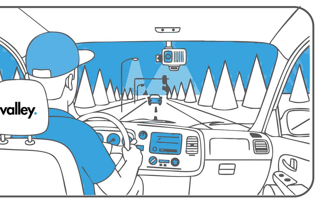 AI dashcam mounted on a semi-truck windshield recording the highway for trucking insurance claims